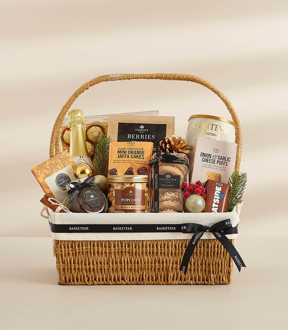 Woven wicker New Year gift hamper with sparkling wine, gourmet chocolates, and artisan treats