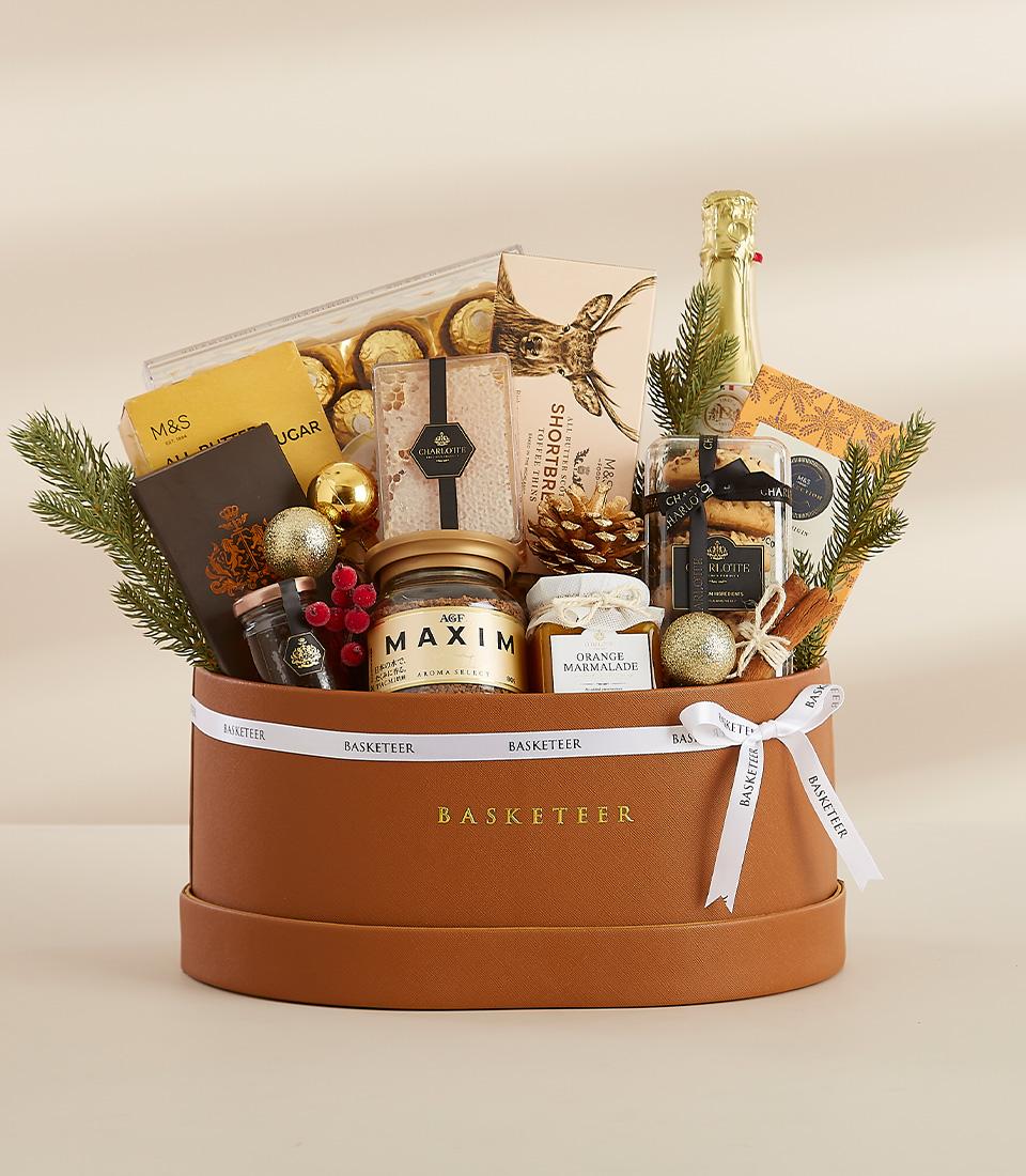 Luxury Merriment gift hamper in brown leather box with champagne, chocolates, and festive decorations for New Year