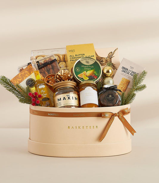 Gilded Gatherings luxury gift box with gourmet foods, coffee, jam, and truffle oil in beige leather basket with gold bow
