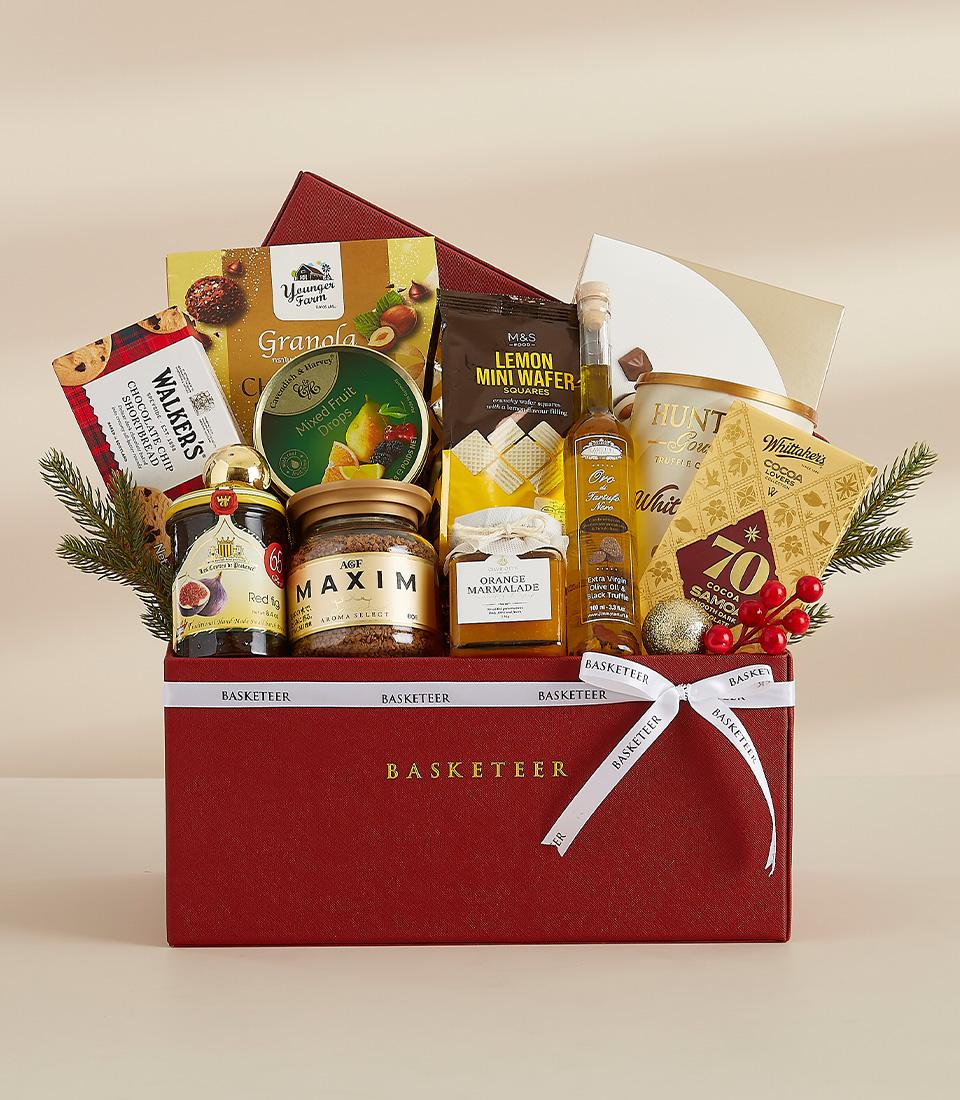 Ultimate indulgence gourmet gift box with chocolate, jam, coffee and truffle oil, festive red packaging with white ribbon