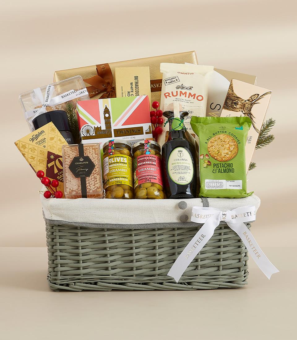 Grey wicker luxury gift basket with gourmet treats, chocolates, pasta, and olives for premium gifting