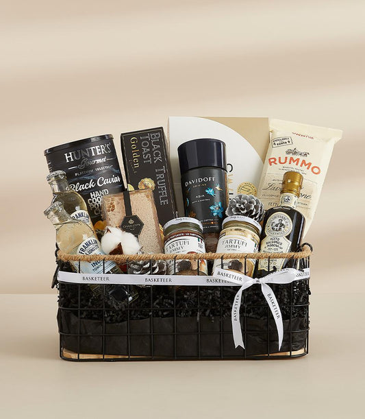 Luxury gourmet hamper with caviar, truffle products, balsamic vinegar, and artisan pasta in black wire basket