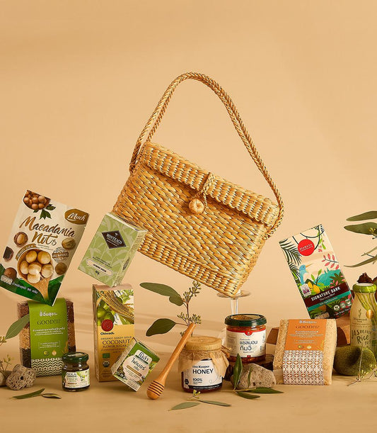 Healthy Harvest curated gift hamper with organic nuts, tea, honey, chocolate and grains in woven straw basket