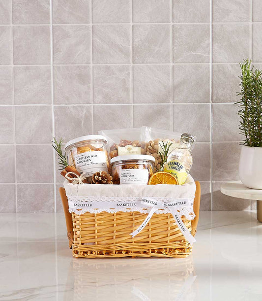Woven wicker gift basket with gourmet cashews, caramel corn flakes, nuts, and artisan preserves for New Year relaxation