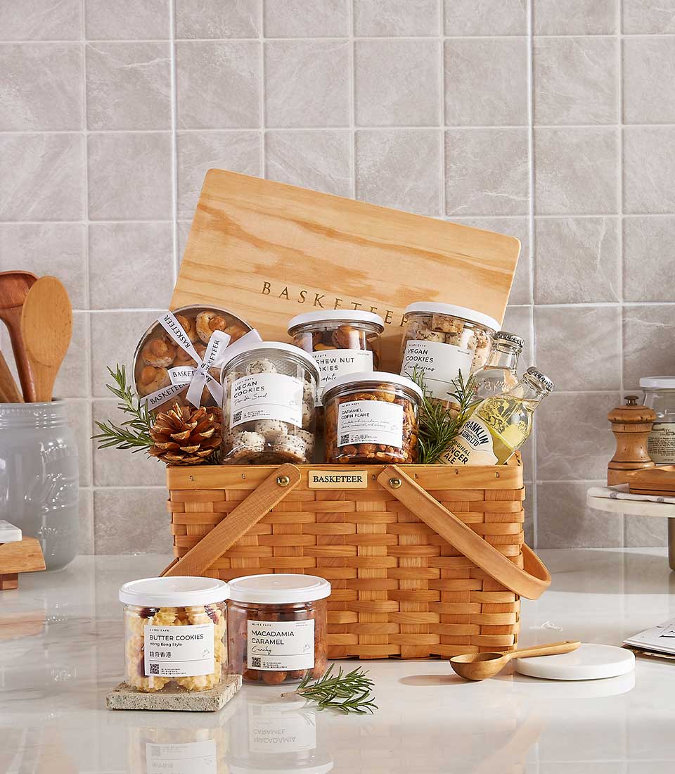 Warm Wishes luxury gift basket with gourmet chocolates, cookies, nuts, and ginger ale in woven picnic-style carrier