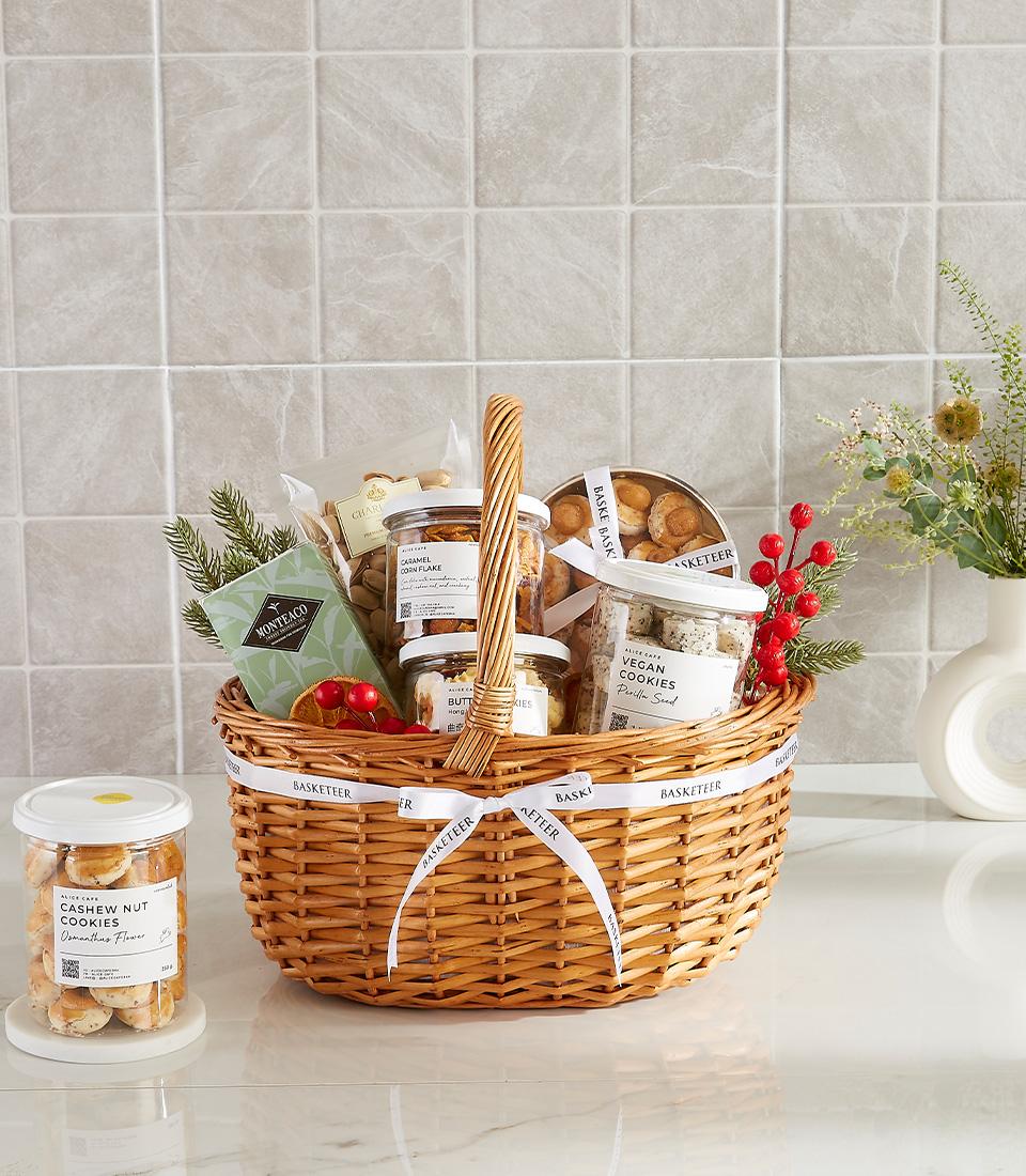Woven wicker gift basket filled with gourmet snacks, cookies, and caramel corn flakes, tied with white ribbon for New Year