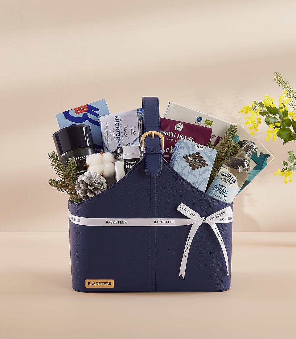 Navy leather executive gift basket with gourmet selections, gold-buckle strap, and premium spirits for New Year