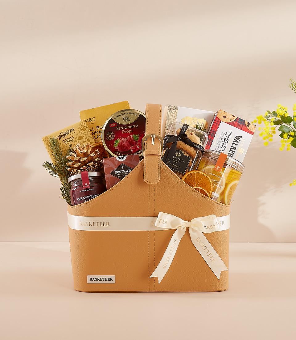 Luxury New Year gift basket with gourmet treats, strawberry jam, chocolate shortbread, and dried citrus in structured tan