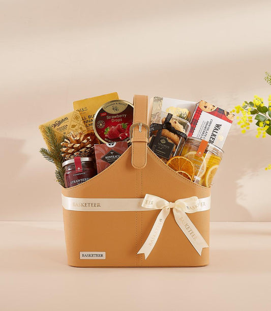Luxury New Year gift basket with gourmet treats, strawberry jam, chocolate shortbread, and dried citrus in structured tan
