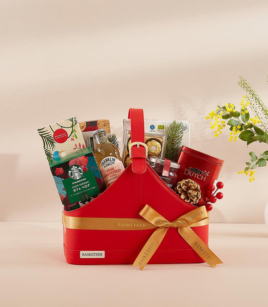 Red leather gift basket with gourmet treats, gold ribbon, and festive styling for New Year celebrations