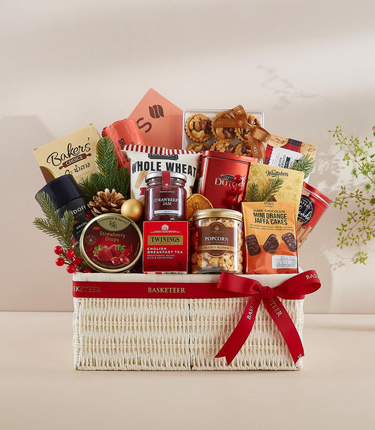Premium New Year gift hamper with gourmet treats, tea, jam, and chocolate in white woven basket with red ribbon