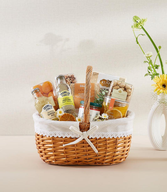 Sunshine Delight wicker gift basket with ginger ale, tonic water, dried fruits, nuts, and crackers for New Year wellness