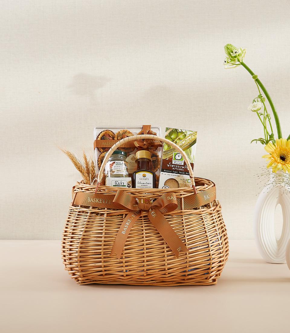 Woven wicker gift basket filled with gourmet treats, artisan baked goods, and wellness essentials for New Year gifting