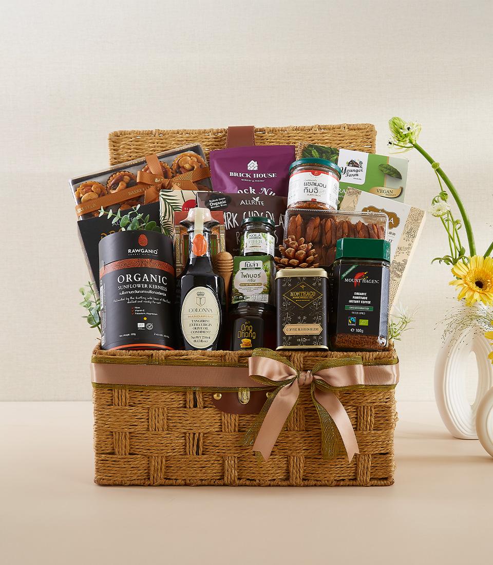 Woven gourmet gift basket with organic kernels, olive oil, coffee, and artisan spreads for new year wellness