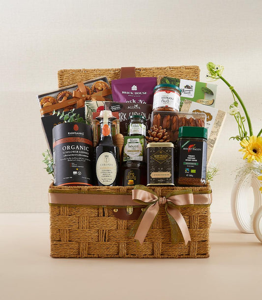 Woven gourmet gift basket with organic kernels, olive oil, coffee, and artisan spreads for new year wellness