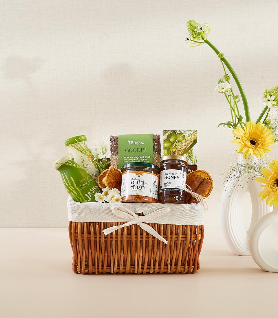 Woven wicker wellness basket with honey, brown rice, spices, and dried citrus for New Year health gifts