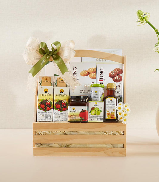 Premium wooden gift basket with artisan cookies, berry juice, honey, and jam in light natural wood