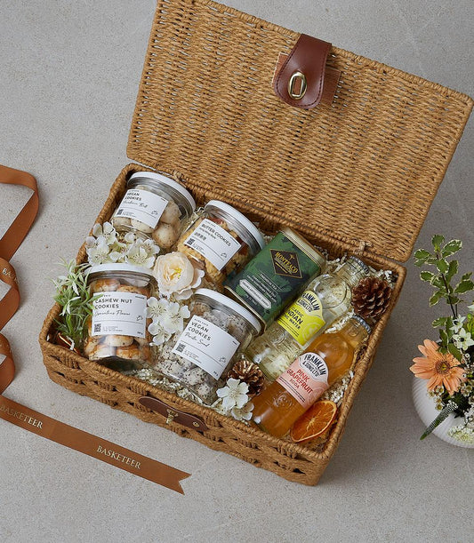 Basketeer premium hamper delivery Thailand. Wicker picnic basket with cashew nut cookies, vegan cookies, and artisanal sodas. Perfect corporate gift Bangkok.