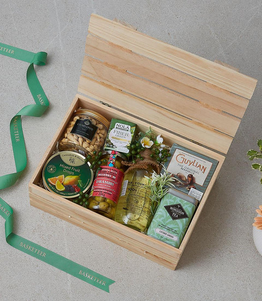 Deluxe wooden gift hamper with gourmet selection, nuts, chocolates, tea and olives in natural gift box