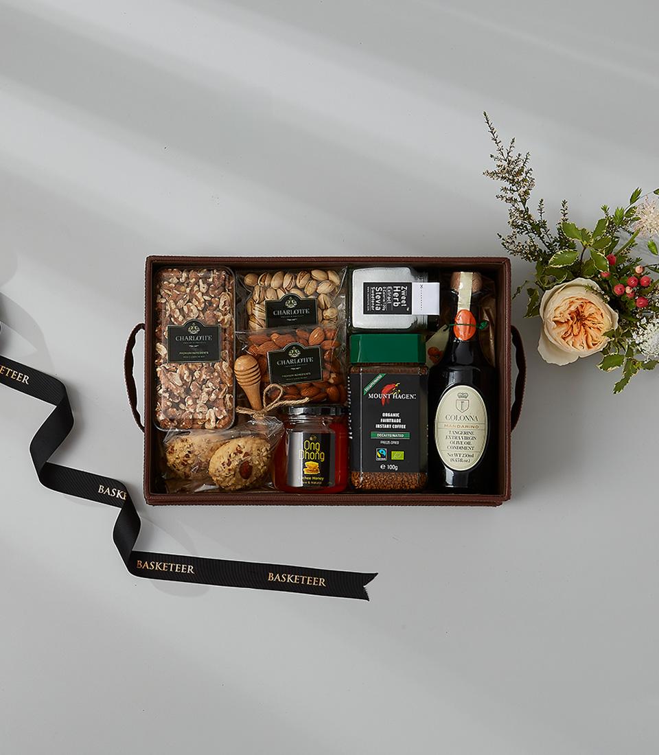 Luxury gourmet nut and coffee hamper with walnuts, almonds, honey, and balsamic vinegar in brown leather box, New Year gift