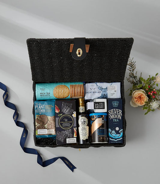 Black woven luxury hamper with gourmet biscuits, crackers, coffee, tea, and balsamic vinegar gift set