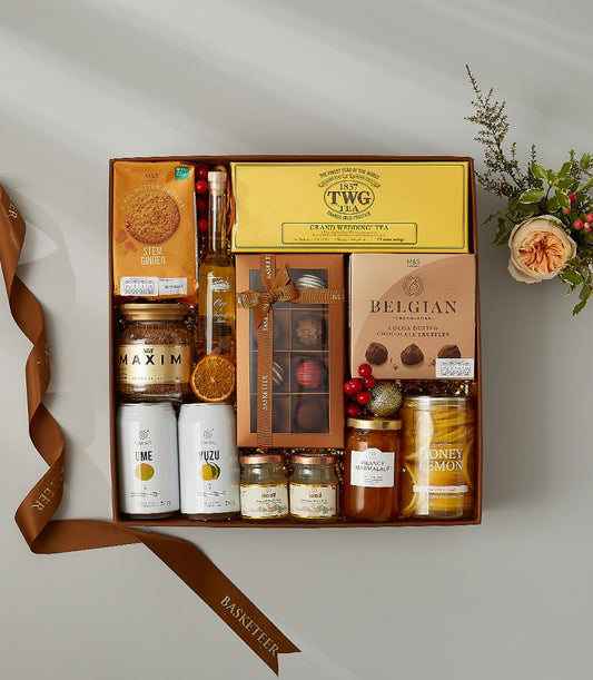 Luxury tea and chocolate gourmet gift hamper with premium preserves and artisan treats in leather basket