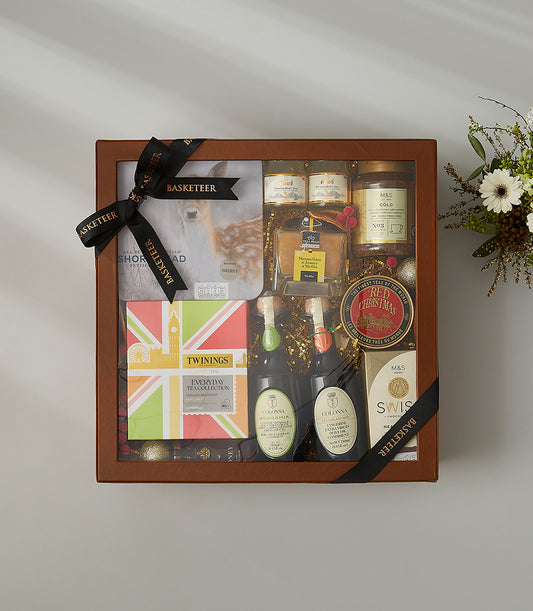 Festive Tea & Treats holiday gift hamper with gourmet teas, preserves, and premium treats in luxury brown box with ribbon bow