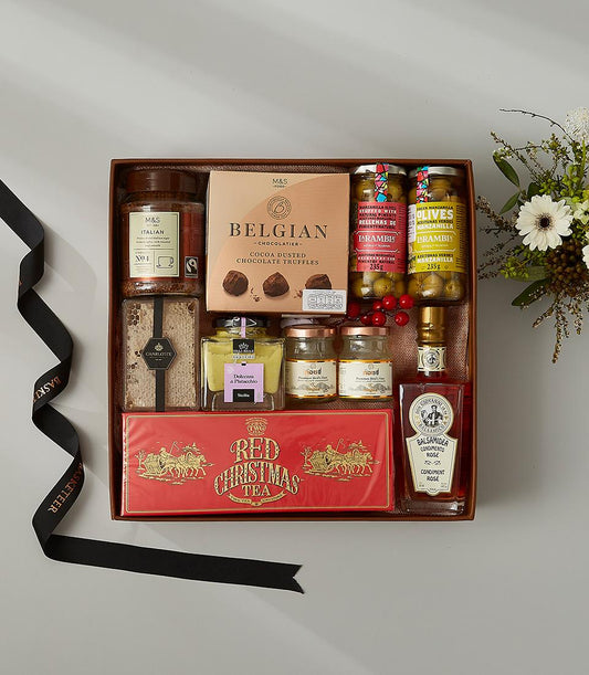 Luxury gourmet gift hamper with Italian coffee, Belgian chocolates, olives, pistachio cream, and festive tea in brown