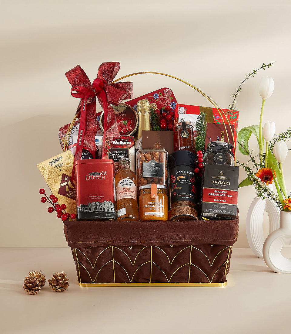 Luxury gourmet hamper with sparkling wine, chocolates, and specialty foods, gold metal frame with red bow, New Year gift