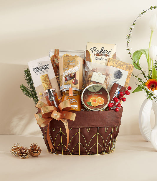 Golden Harvest gourmet gift basket with chocolates, nuts, marmalade, and festive gold ribbon for New Year gifting