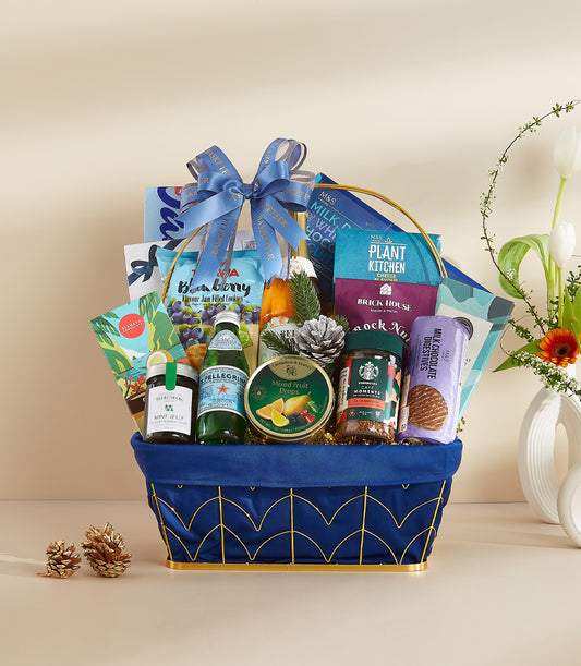 Royal blue gourmet gift basket with premium snacks, coffee, and sparkling water for New Year celebrations