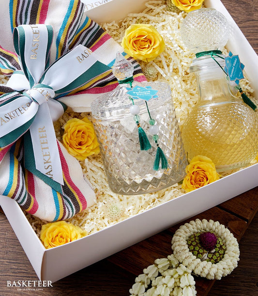Thai traditional perfume gift set with glass bottles, scented powder, and yellow roses in white presentation box for Songkran