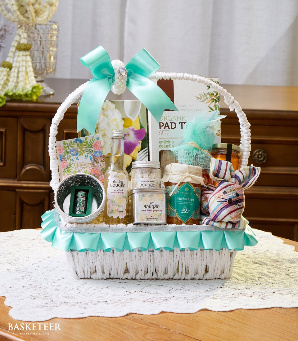Thai Songkran white woven gift basket with scented water, potpourri, marian plum preserve, and festive accents