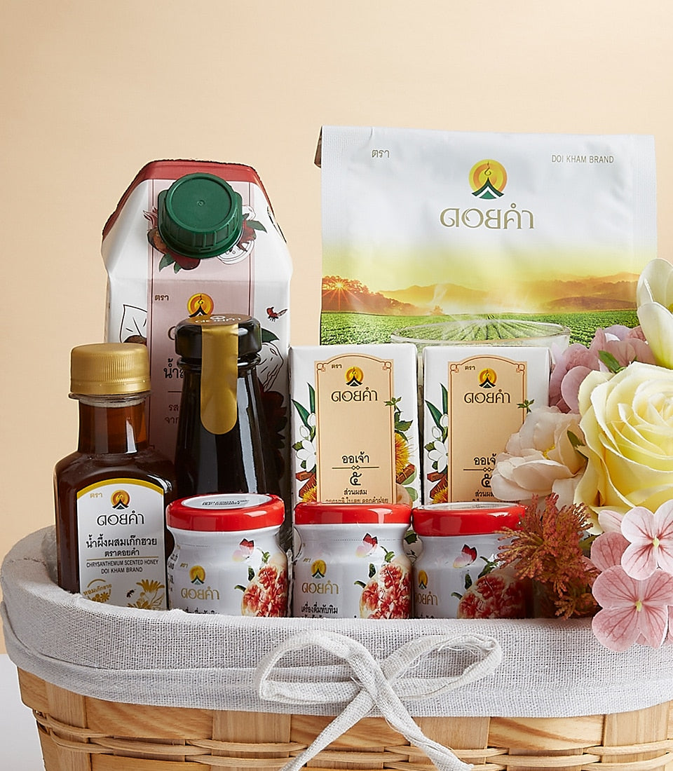 Woven gift basket with Doi Kham health and wellness products, fresh flowers, and artisan treats for premium gifting