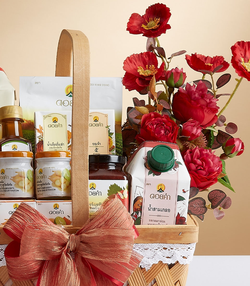 Premium woven gift basket with red ribbon bow, filled with Doi Kham health and wellness products, jars, and pouches