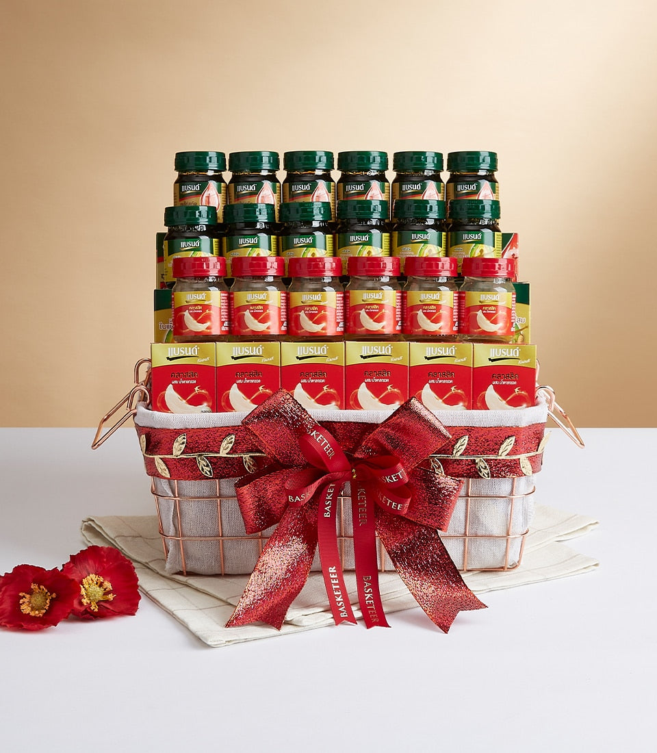Luxury gift basket with rose gold wire frame, grey linen, red ribbon bow filled with artisan gourmet jars and wellness