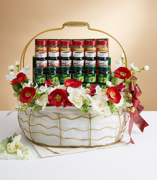 Luxury wellness gift basket with red, white, and green-capped bottles, white fabric lining, gold wire frame, and mixed red