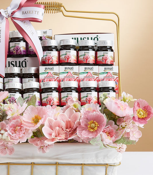 Luxury mixed wellness gift basket with gold frame, berry supplement bottles, and artificial pink peonies