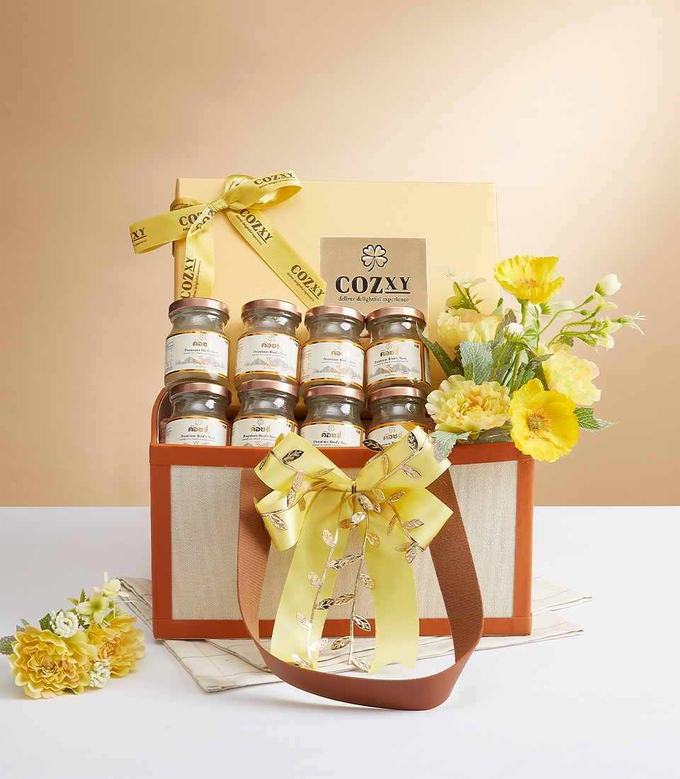 Premium bird's nest gift set with rose gold jar lids in luxury beige box, paired with yellow and white flowers