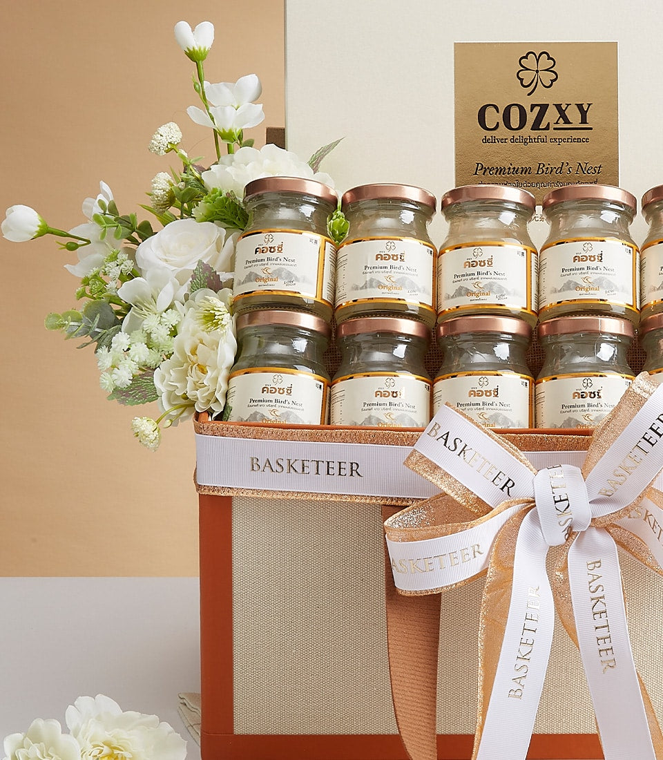 Premium bird's nest gift box with twelve glass jars, white flowers, and rose gold accents
