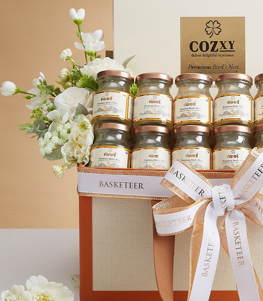 Premium bird's nest gift box with twelve glass jars, white flowers, and rose gold accents