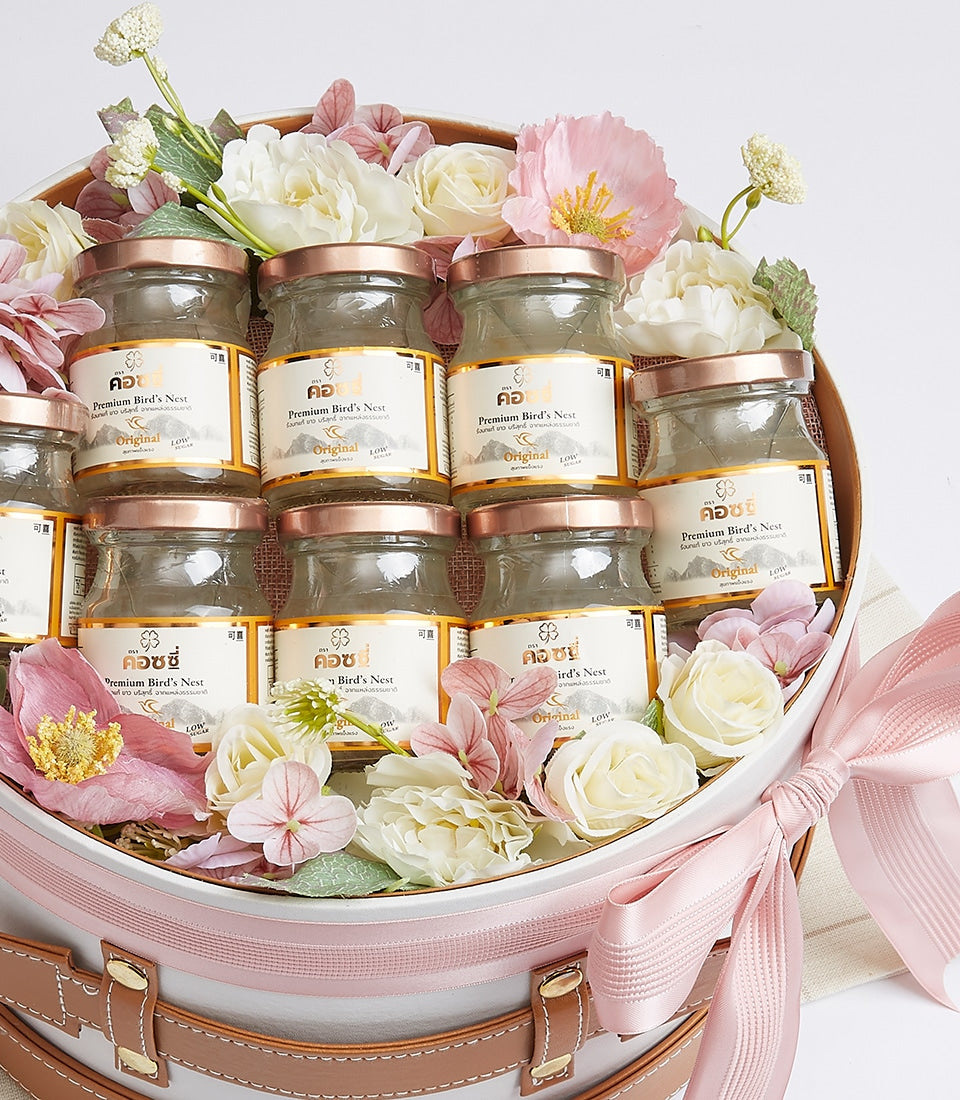Premium bird's nest gift box with rose gold jar lids, white leather-accents, and pink ribbon bow