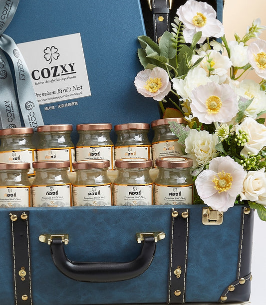 Vintage blue suitcase luxury gift set with premium bird's nest jars, white and pink artificial flowers, artisan health and
