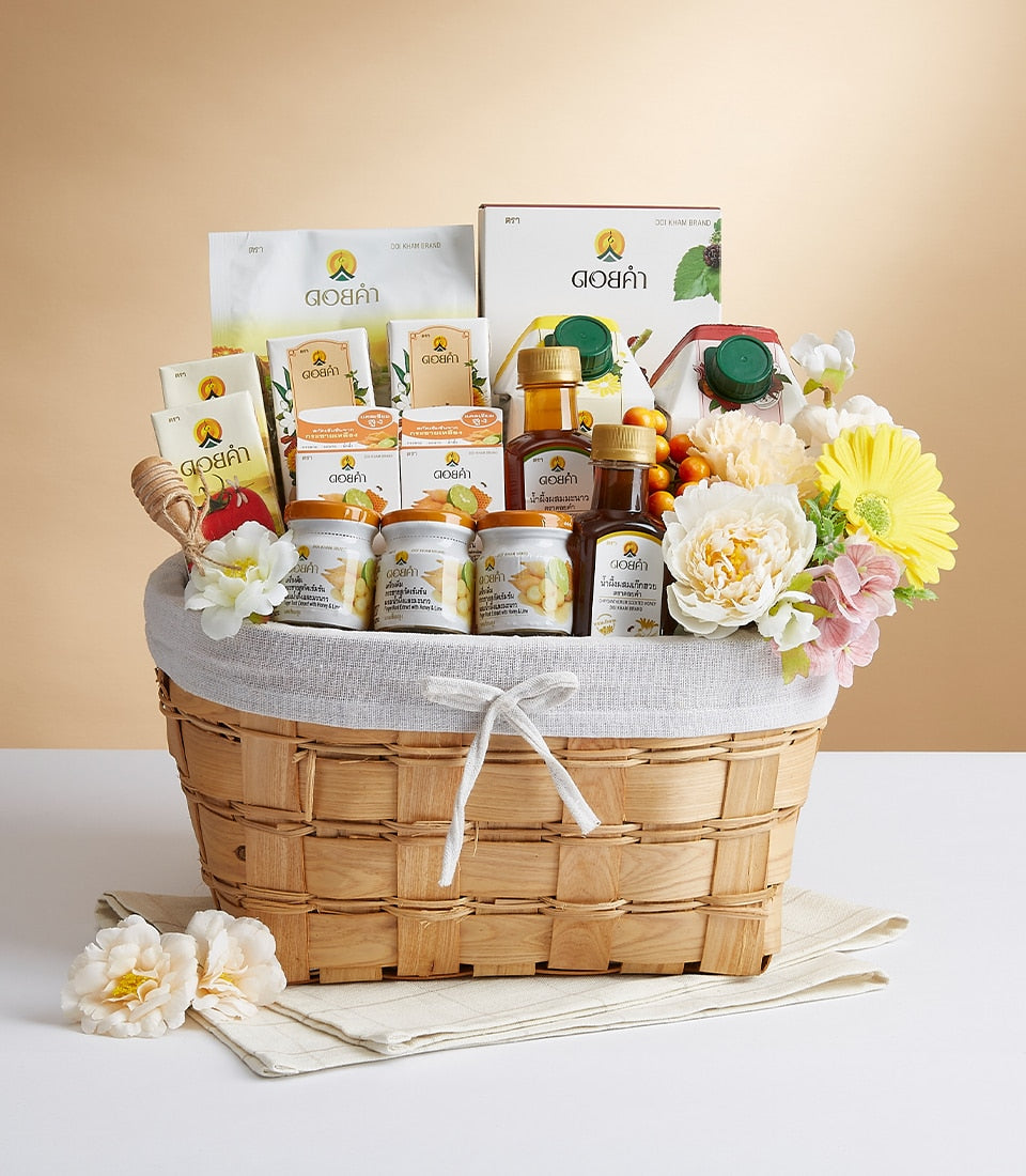 Premium woven gift basket with Doi Kham health and wellness products, artificial florals, and white ribbon