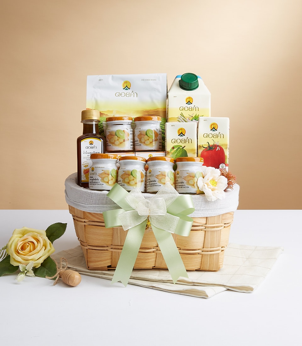 Woven wood gift basket with light green ribbon, filled with Doi Kham preserved fruits, nuts, and gourmet products