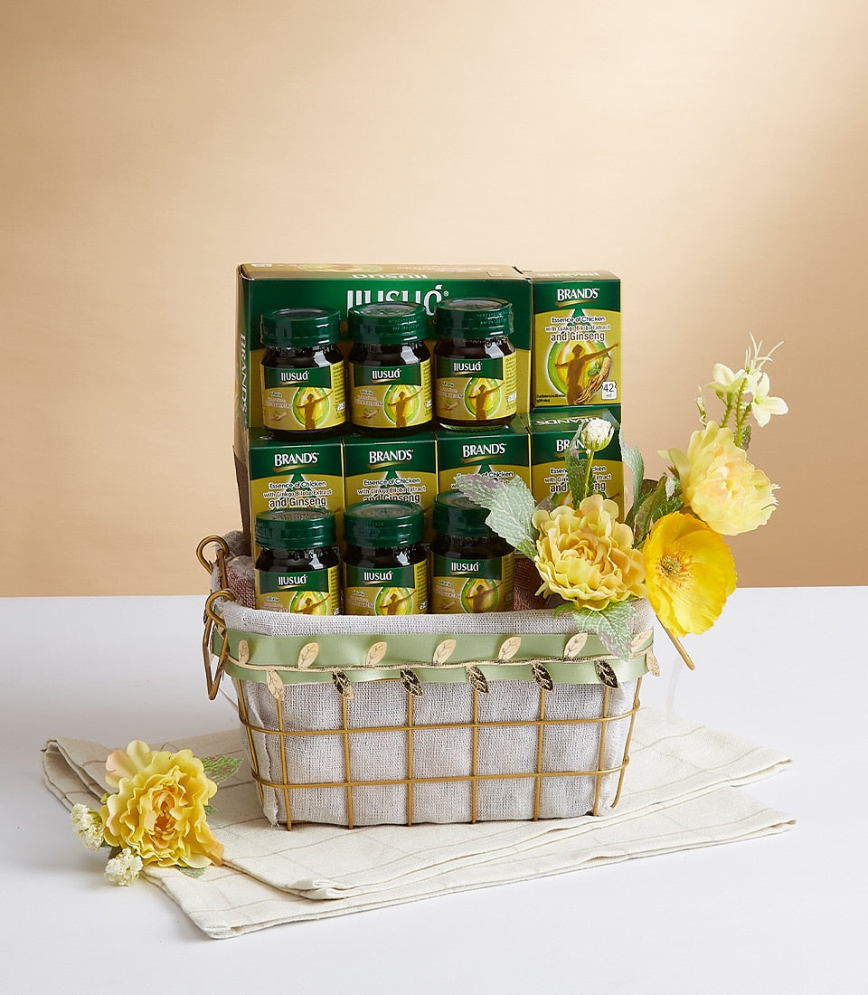 Premium health supplement gift basket with chicken extract bottles, ginseng, and cordyceps in gold wire basket with green