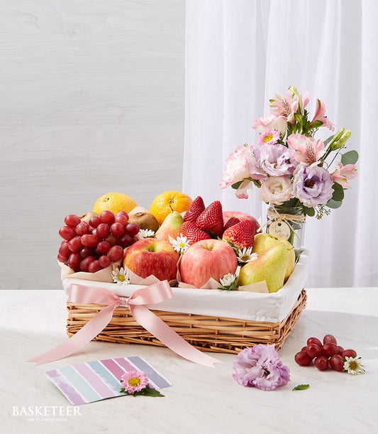 Fresh fruit basket with grapes, apples, pears and berries plus pink flower arrangement, get well gift