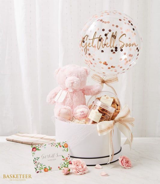 Get well gift hamper with pink teddy bear, confetti balloon, gourmet cookies, and fresh carnations in white hatbox