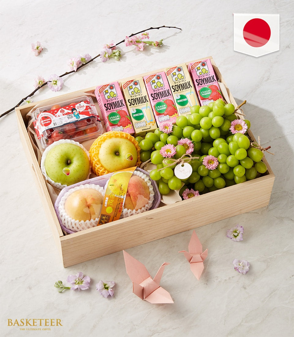 Wooden fruit gift box with green apples, peaches, red grapes, cherry tomatoes, and soymilk cartons