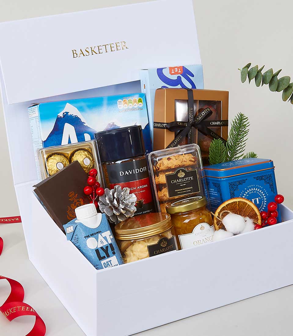 Luxurious white gift box filled with gourmet treats, coffee, cookies, and festive decorations for New Year gifting